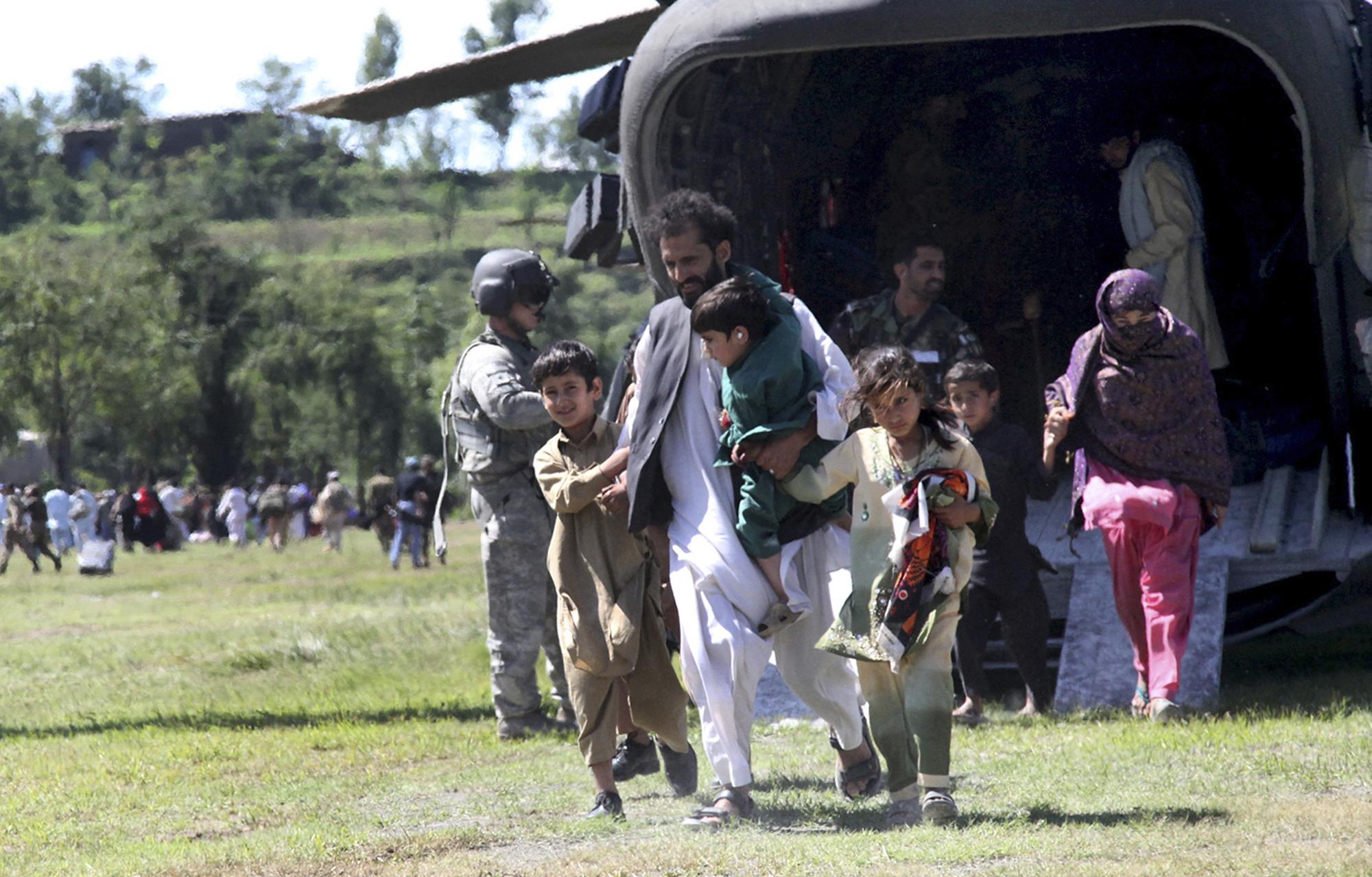 Une famille déplacée sort d'un hélicoptère de l'armée américaine dans la ville de Khwazakhela, dans la vallée du Swat.