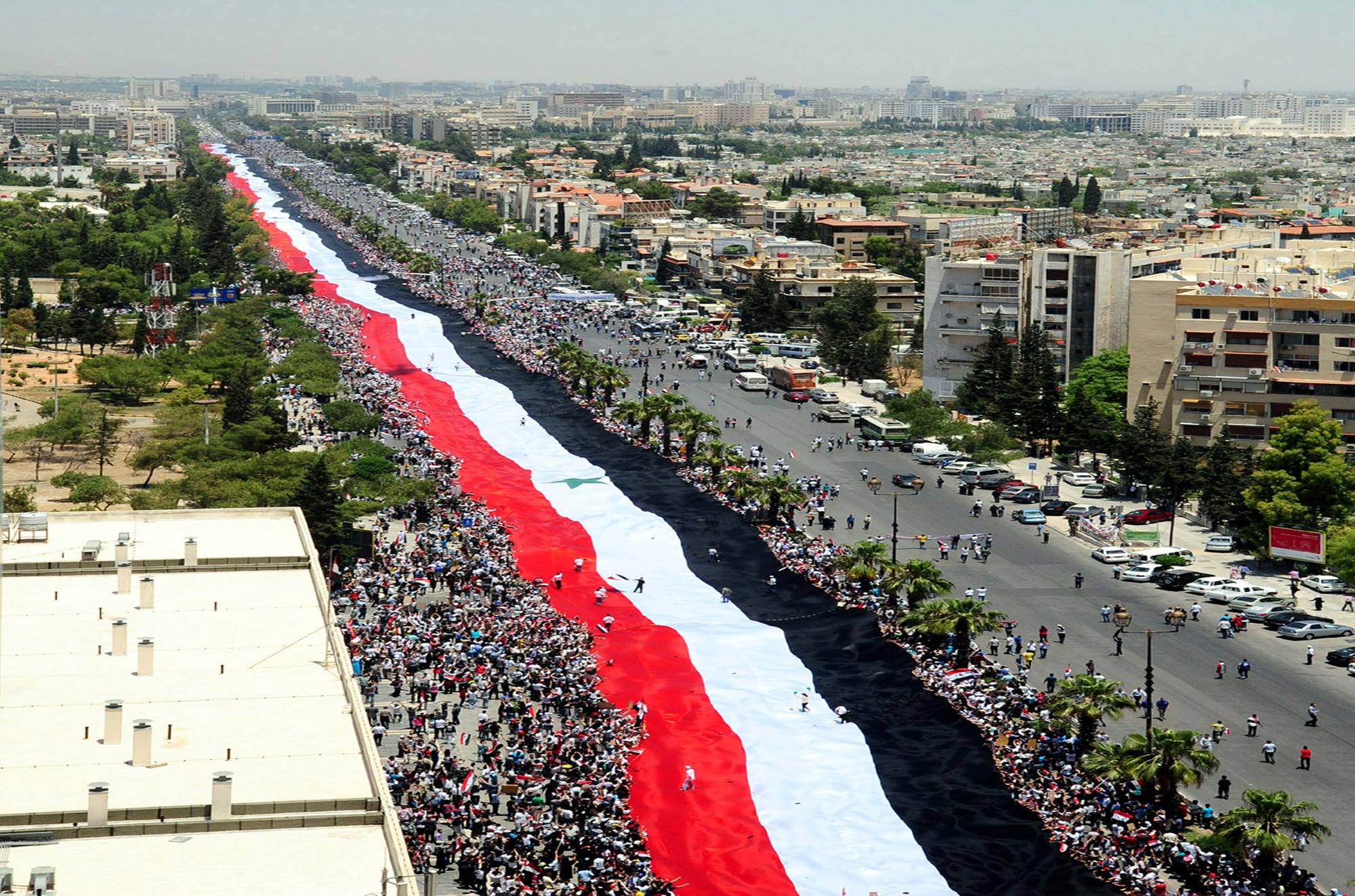 Le plus grand drapeau syrien jamais déployé, à l'occasion d'une manifestation à Sana le 15 juin 2011. [REUTERS - Sana/Handout]
