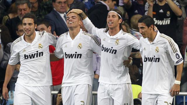 Real Madrid's Sergio Ramos, second right, celebrates his goal with Angel Di Maria from Argentina, right, Pepe from Portugal, second left, Gonzalo Higuain from Argentina, left, during a Group D Champions League soccer match against Lyon at the Santiago Bernabeu stadium in Madrid, Tuesday, Oct. 18, 2011. (AP Photo/Andres Kudacki) [Andres Kudacki]