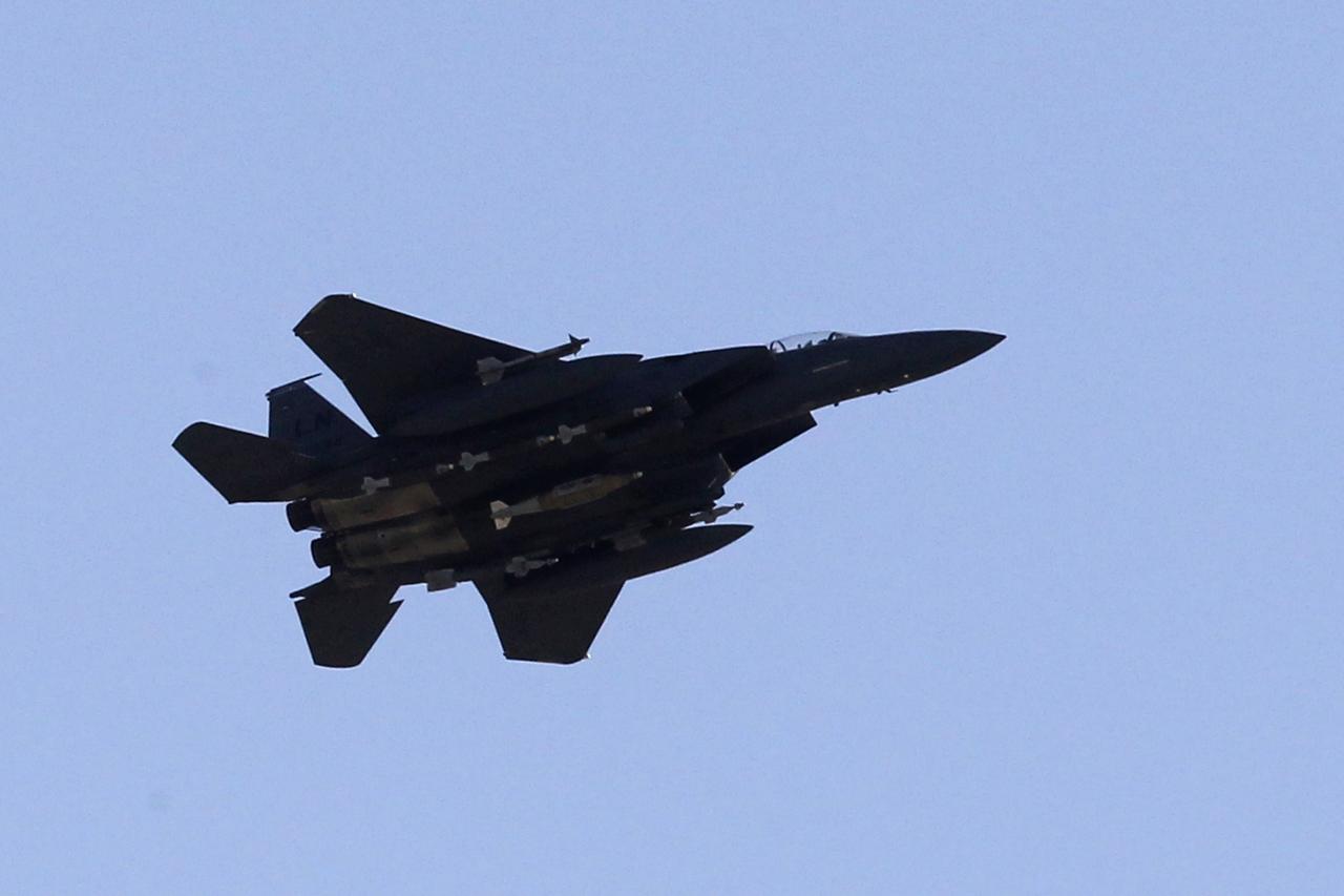 A US Air Force F-15 aircraft flies over Afghan and French soldiers participating in operation Spear Tackle 2 in Surobi district on September 26, 2010. Most of France's 3,500 soldiers, who are part of a NATO-led multinational force fighting the Taliban inside Afghanistan, are based in districts around Kabul. AFP PHOTO/Joel SAGET [AFP - Joël Saget]