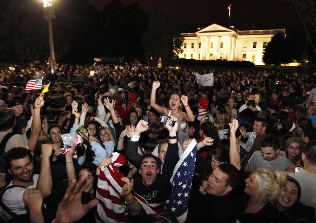 La foule s'est rassemblée très tôt lundi devant la Maison Blanche à Washington D.C. pour célébrer la mort d'Oussama Ben Laden, le chef de l'organisation terroriste Al-Quaïda. [KEYSTONE - Manuel Balce Ceneta]