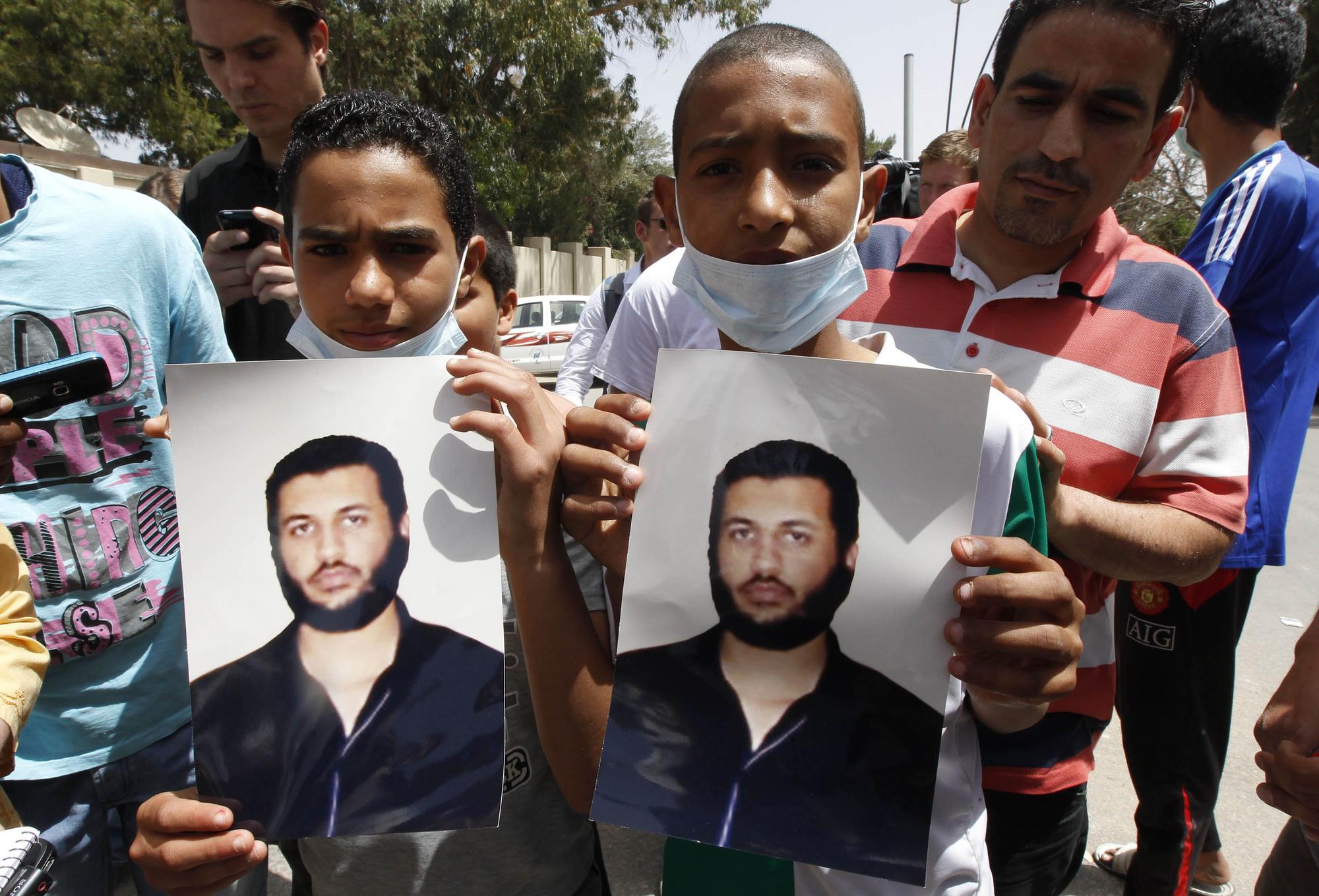 Young men hold pictures of Saif Al-Arab Gaddafi, son of Libyan leader Muammar Gaddafi, in Tripoli May 1, 2011. Libya said on Sunday Muammar Gaddafi's youngest son Saif Al-Arab and three grandchildren were killed in a NATO air strike and Britain said that while it was not targeting the leader, it was homing in on his military machine. Libyan government spokesman Mussa Ibrahim said Gaddafi was unharmed and in good health despite what he called "a direct operation to assassinate the leader of this country". The deaths have not been independently confirmed. REUTERS/Louafi Larbi [REUTERS - Louafi Larbi]
