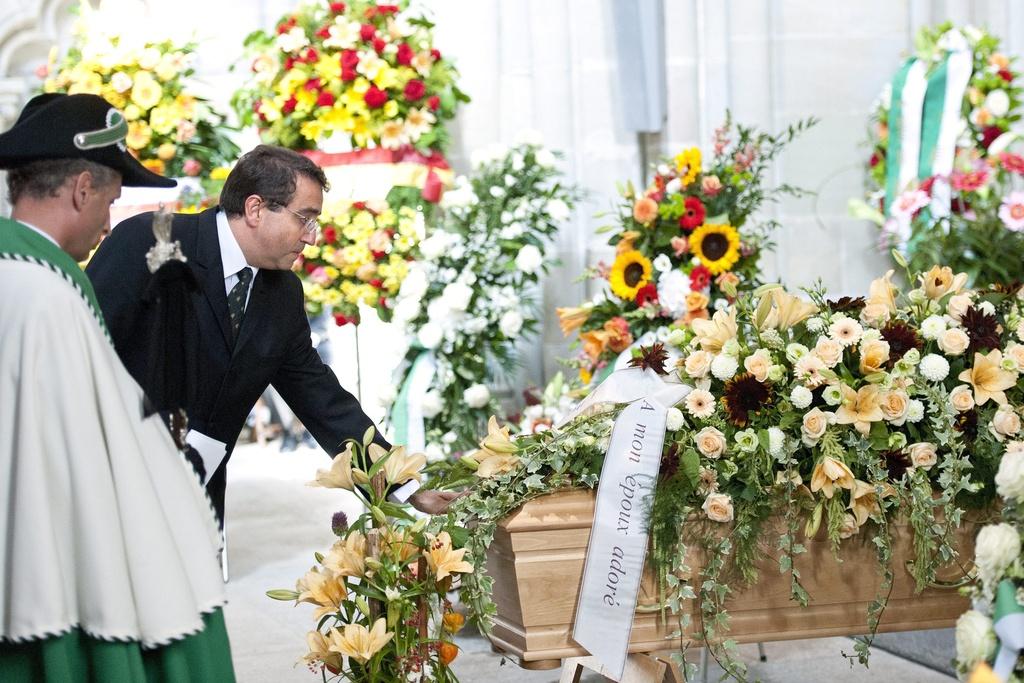 Le président du Conseil d'Etat vaudois Pascal Broulis se recueille devant le cercueil de son collègue. [KEYSTONE - Laurent Gillieron]