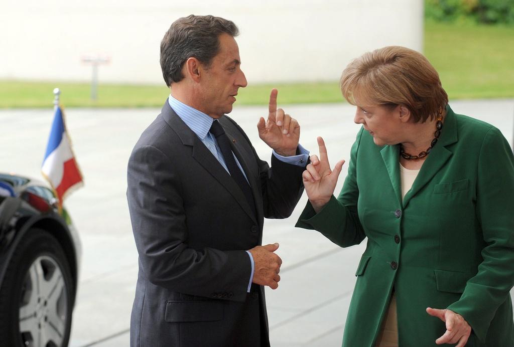 Le président français Nicolas Sarkozy et la chancellière allemande Angela Merkel se rencontraient ce jeudi à Bruxelles. [Keystone - Maurizio Gambarini]
