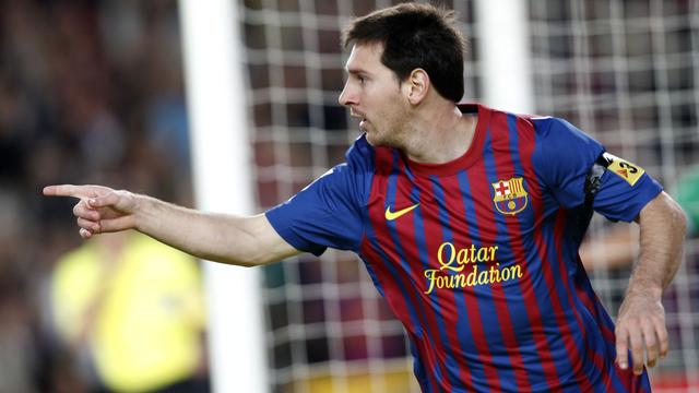 Barcelona's player Lionel Messi celebrates his goal against Racing de Santander during their Spanish first division soccer match at Nou Camp stadium in Barcelona October 15, 2011. REUTERS/Gustau Nacarino(SPAIN - Tags: SPORT SOCCER) [Gustau Nacarino]