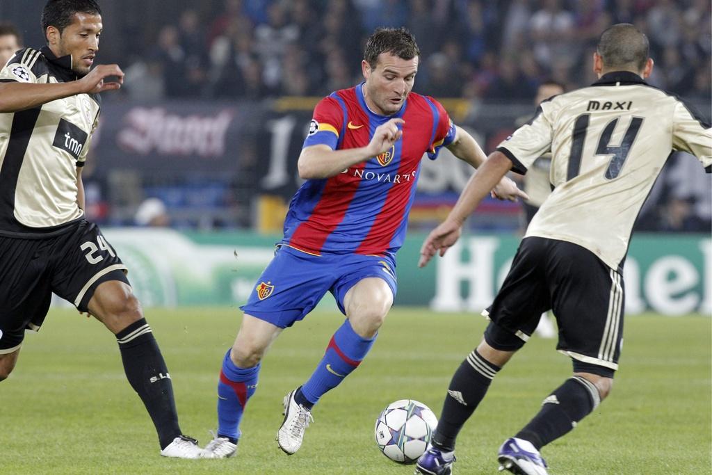 Basel's Alex Frei, center, fights for the ball with Benfica's Ezequiel Garay, left and Benfica's Maxi Pereira, right, during the Champions League group stage, group C, soccer match between Switzerland's FC Basel and Portugal's Benfica Lisbon, at the St. Jakob-Park stadium in Basel, Switzerland, Tuesday, October 18, 2011. (KEYSTONE/Alessandro Della Bella) [Keystone - Alessandro Della Bella]