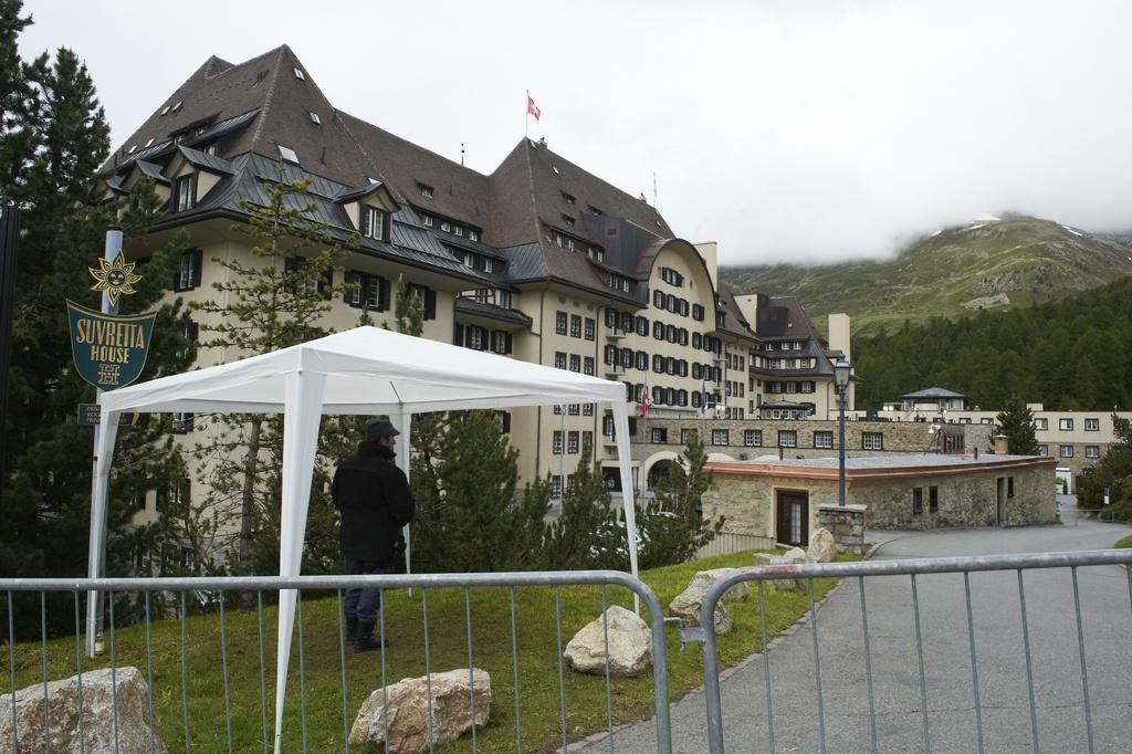 Un garde surveille l'entrée de l'hôtel Suvretta à St-Moritz, où se déroule depuis jeudi la conférence de Bilderberg qui a lieu chaque année depuis 1954. [KEYSTONE - Giancarlo Cattaneo]