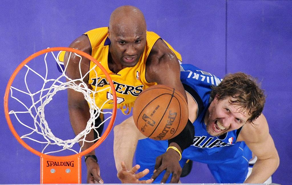 Lamar Odom (jaune) à la lutte pour un rebond avec Dirk Nowitzki. [Keystone - Mark J. Terrill]