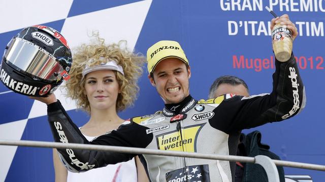 Switzerland's Thomas Luthi celebrates on the podium after taking a third place during the Italian Moto2 Grand Prix, at the Mugello race circuit, in Scarperia, Italy, Sunday, July 15, 2012. (AP Photo/Antonio Calanni) [KEYSTONE - Antonio Calanni]