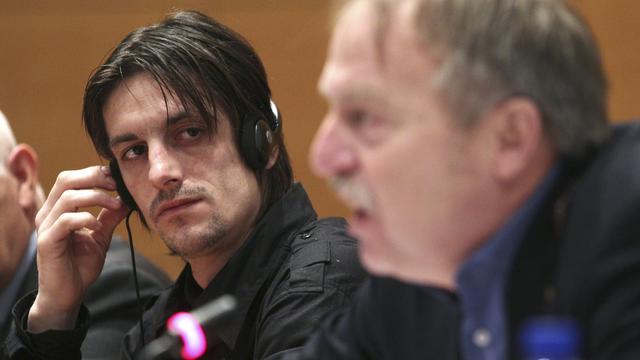 Serbian soccer player Dragisa Pejovic, left, looks on as Theo Van Seggelen, Secretary General of FIFPro, the World Players Union, addresses the media on the FIFPro Black Book for Eastern Europe in Brussels, Tuesday, Feb. 7, 2012. The union representing professional footballers says players are being mistreated by clubs in Eastern Europe, in some cases leading to the greater risk of match-fixing. FIFPro says clubs in Eastern Europe show a "terrifying lack of respect" for fundamental rights of professionals, ranging from withholding wages to beatings. The trade union threatened to hold up the start of some UEFA Champions League matches if it failed to get commitments the situation would improve. (AP Photo/Yves Logghe) [Yves Logghe]