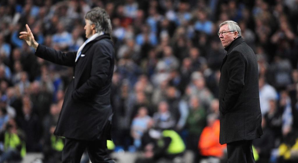 epa03201847 Manchester City manager Roberto Mancini (L) and Manchester United manager Sir Alex Ferguson (R) react during the English Premier League soccer match at the Etihad Stadium, Manchester, Britain, 30 April 2012. EPA/PETER POWELL DataCo terms and conditions apply. http//www.epa.eu/downloads/DataCo-TCs.pdf [Peter Powell]