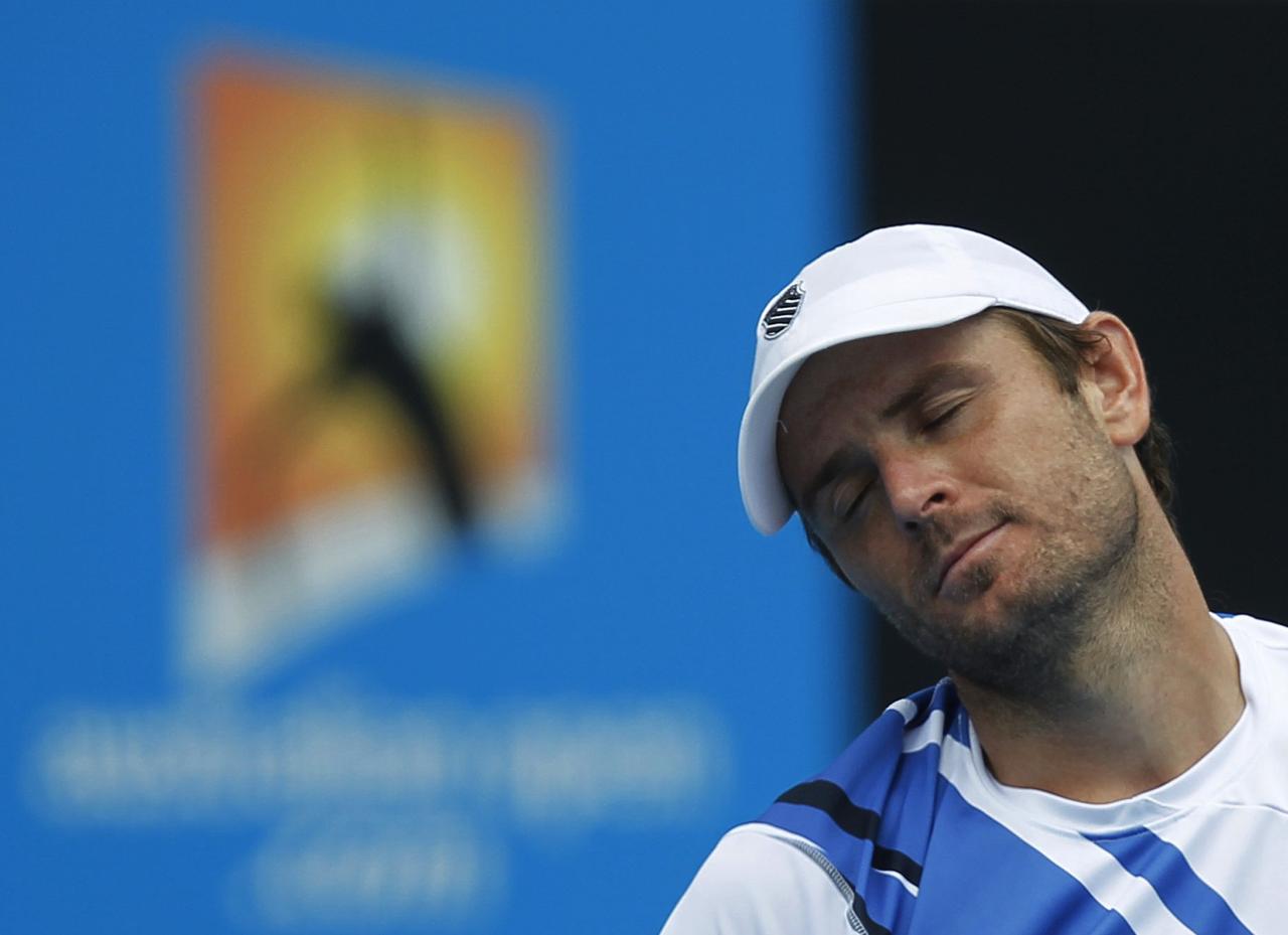 Mardy Fish of the U.S. reacts to losing a point during his men's singles match against Alejandro Falla of Colombia at the Australian Open tennis tournament in Melbourne January 18, 2012. REUTERS/Vivek Prakash (AUSTRALIA - Tags: SPORT TENNIS) [Vivek Prakash]