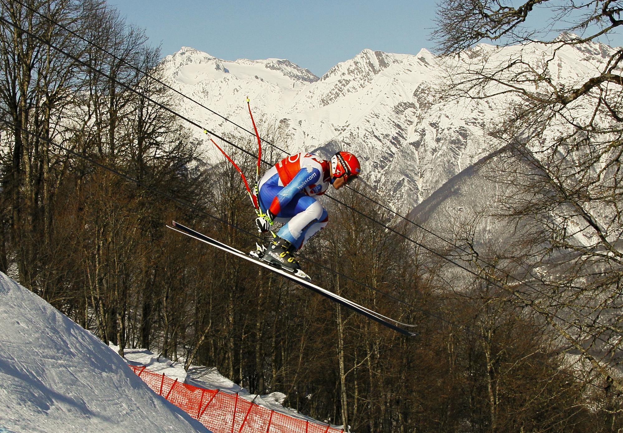Didier Cuche of Switzerland clears the "Russian Trampoline" jump during the first practice run for the men's Alpine Skiing World Cup Downhill race in Rosa Khutor near Sochi February 8, 2012. REUTERS/Wolfgang Rattay (RUSSIA - Tags: SPORT SKIING) [Wolfgang Rattay]
