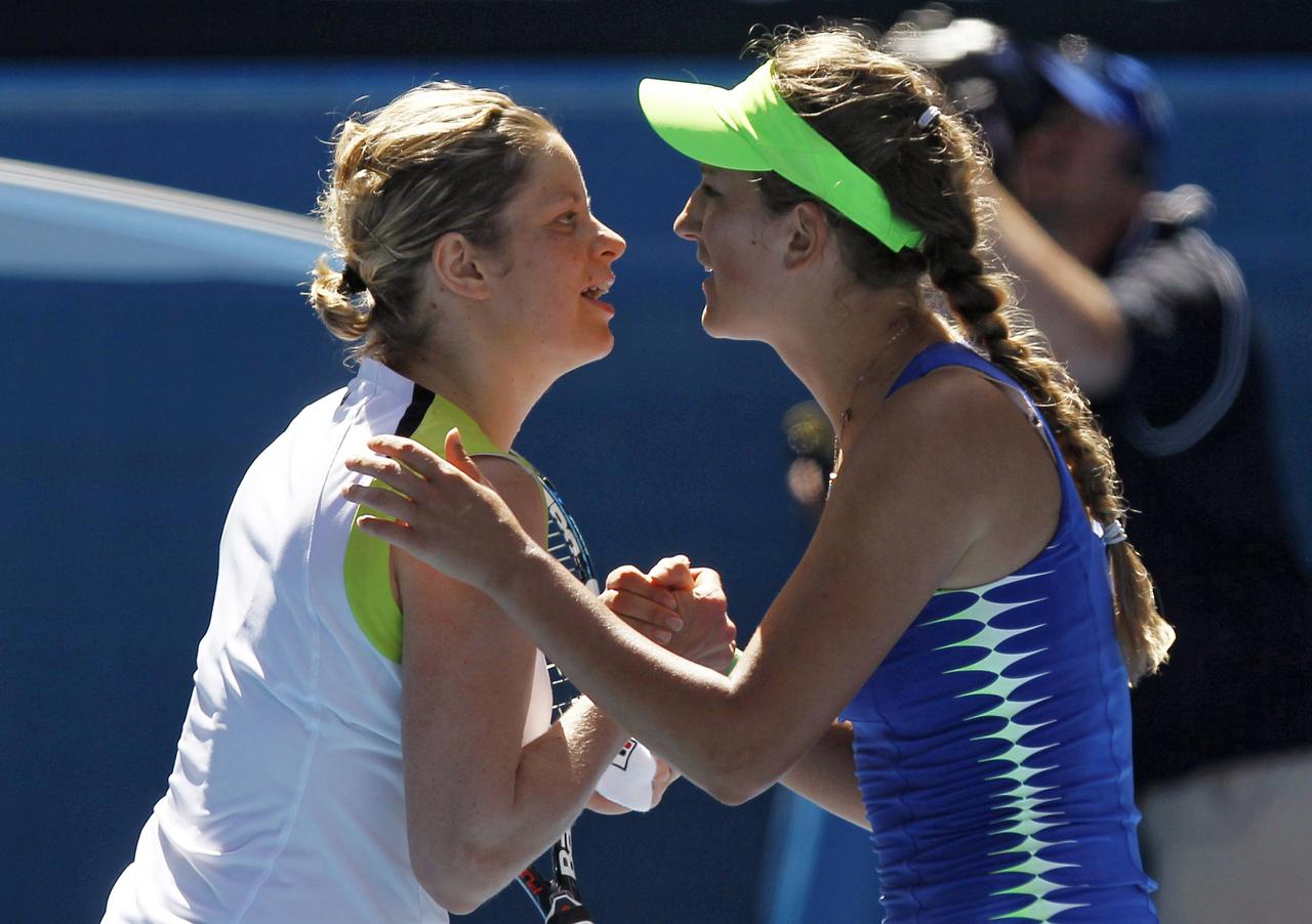 Victoria Azarenka of Belarus (R) kisses Kim Clijsters of Belgium after their women's singles semi-final match at the Australian Open tennis tournament in Melbourne January 26, 2012. REUTERS/Mark Blinch (AUSTRALIA - Tags: SPORT TENNIS) [REUTERS - Mark Blinch]