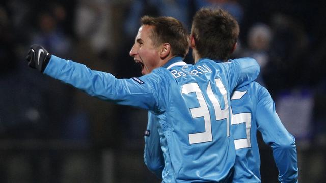 Zenit St. Petersburg's Sergei Semak (R) celebrates with teammate Vladimir Bystrov after scoring against Benfica during their Champions League last 16 first leg soccer match at the Petrovsky stadium in St. Petersburg February 15, 2012. REUTERS/Alexander Demianchuk [Alexander Demianchuk]