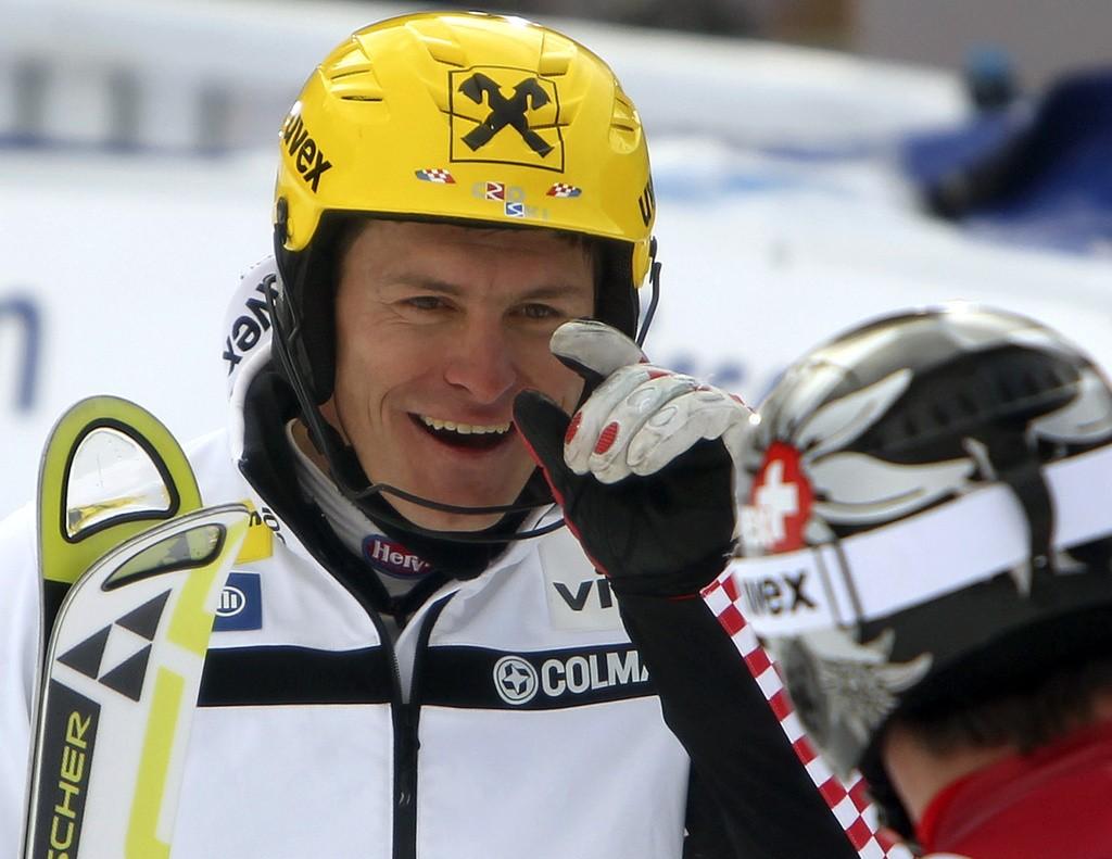 Croatia's Ivica Kostelic, left, gestures to second placed Beat Feuz of Switzerland smiles after winning an alpine ski, men's World Cup super-combined, in Wengen, Switzerland, Friday, Jan. 13, 2012. Ivica Kostelic used a surging slalom run to rise from 23rd place and win a World Cup super-combined race Friday. The Croatian slalom specialist trailed first-run leader Beat Feuz by almost three seconds in downhill, but edged the young Swiss skier for victory by 0.20 seconds. (AP Photo/Marco Trovati) [Trovati]