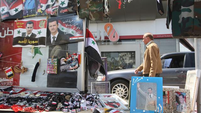Un stand vend des images du président syrien Bachar al-Assad à Damas, en avril 2012. [UAI BESHARA]