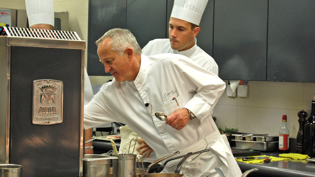 Edgard Bovier, chef exécutif des cuisines du Lausanne Palace, contrôle les assiettes avant leur départ en salle. [Antoine Droux]