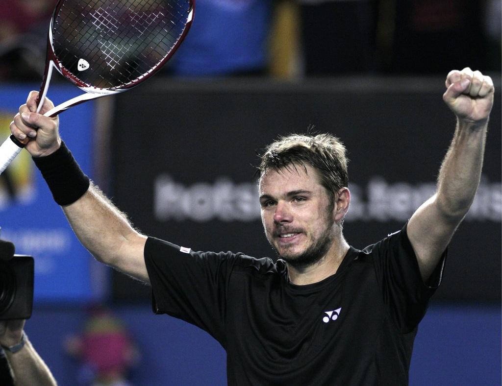 Stanislas Wawrinka of Switzerland celebrates after defeating Marcos Baghdatis of Cyprus in their second round match at the Australian Open tennis championship, in Melbourne, Australia, Wednesday, Jan. 18, 2012. (AP Photo/John Donegan) [John Donegan]