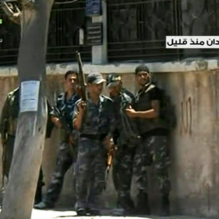 Les forces officielles traquent les rebelles dans certains quartiers de Damas (image TV officielle syrienne). [SANA/Keystone]