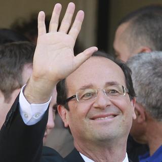 Socialist Party candidate for the presidential election Francois Hollande waves after visitng a polling station near Tulle, central France, Sunday, May 6, 2012. (AP Photo/Bob Edme) [Bob Edme]
