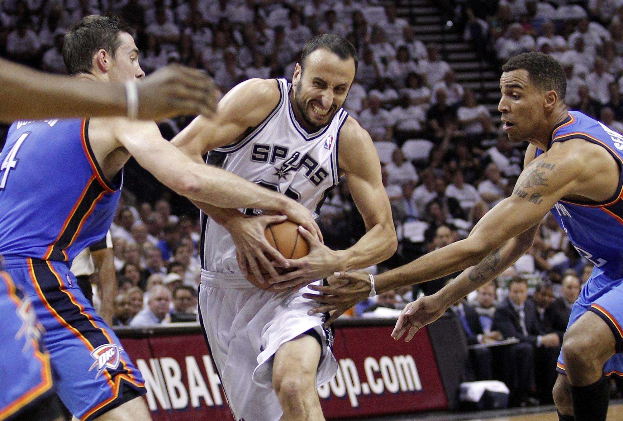 San Antonio Spurs' Ginobili goes to the basket against Oklahoma City Thunder's Collison and Sefolosha in the first half during Game 5 of the NBA Western Conference basketball finals in San Antonio [REUTERS - Tim Sharp]