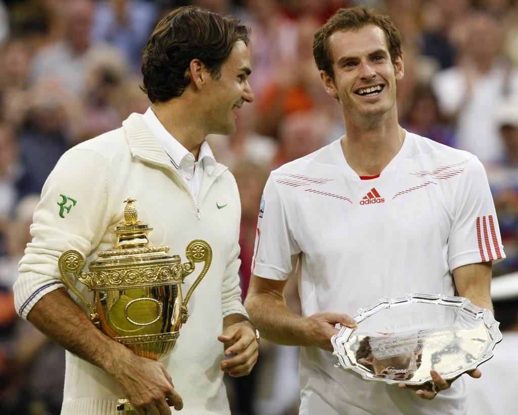 epa03300950 Roger Federer of Switzerland (L) and Andy Murray of Britain (R) hold their trophy following the men's final match for the Wimbledon Championships at the All England Lawn Tennis Club, in London, Britain, 08 July 2012. EPA/JONATHAN BRADY [Jonathan Brady]