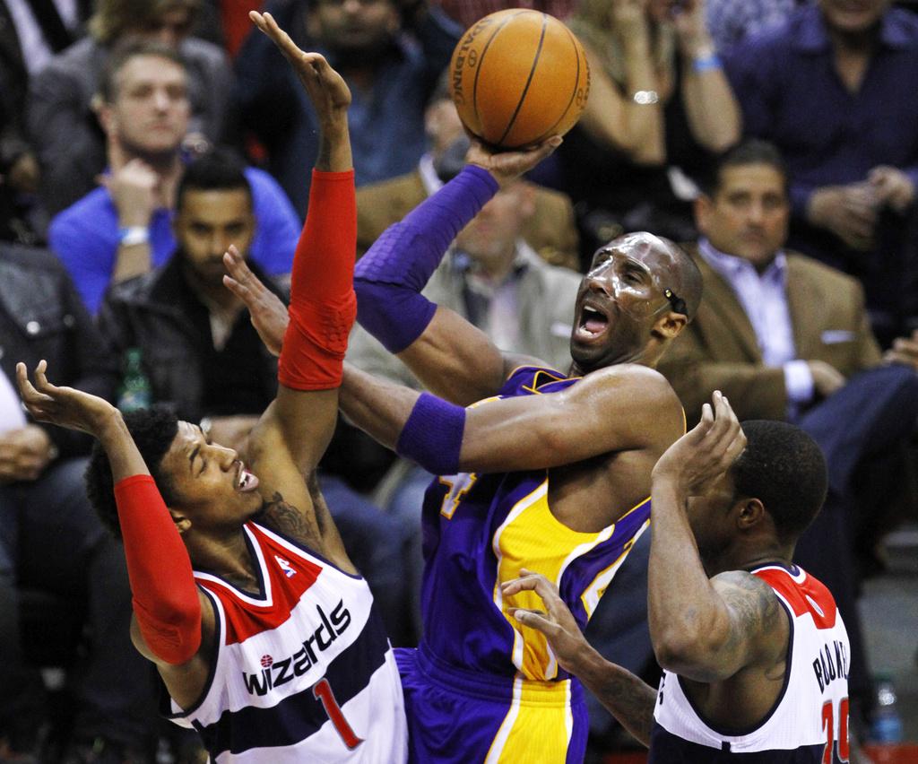 Washington Wizards guard Nick Young (1) and forward Trevor Booker, right, block Los Angeles Lakers guard Kobe Bryant in the third quarter of an NBA basketball game at the Verizon Center in Washington, Wednesday, March 7, 2012. The Wizards won 106-101. (AP Photo/Jacquelyn Martin) [J.Martin]