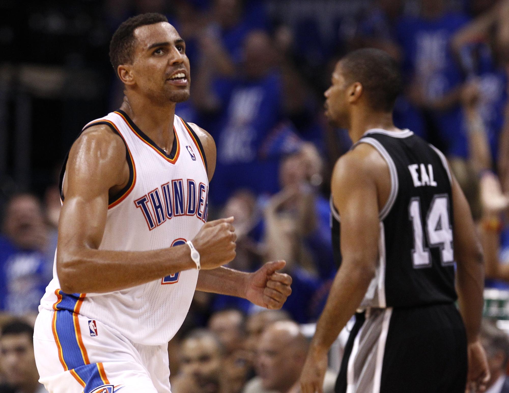 Oklahoma City Thunder shooting guard Thabo Sefolosha (L) celebrates next to San Antonio Spurs point guard Gary Neal (14) in the second half during Game 3 of the NBA Western Conference basketball finals in Oklahoma City, Oklahoma, May 31, 2012 REUTERS/Jim Young (UNITED STATES - Tags: SPORT BASKETBALL) [REUTERS - Jim Young]