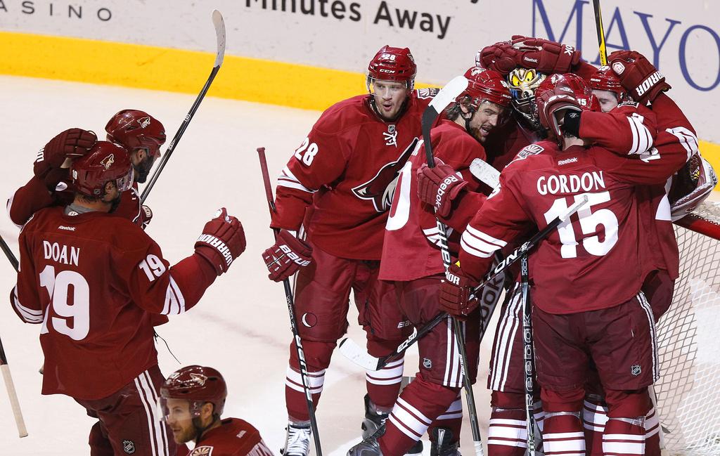 Phoenix Coyotes' Boyd Gordon (15), Lauri Korpikoski (28), of Finland, Shane Doan (19), Oliver Ekman-Larsson, of Sweden, far right, Antoine Vermette (50), and Shane Doan (19) all celebrate with goalie Mike Smith after the third period of Game 5 in an NHL hockey Stanley Cup Western Conference semifinal playoff series against the Nashville Predators Monday, May 7, 2012, in Glendale, Ariz. The Coyotes defeated the Predators 2-1, and advance to the Western Conference finals.(AP Photo/Ross D. Franklin) [Ross D. Franklin]