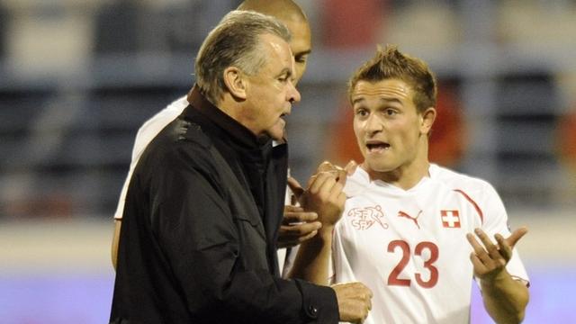 Swiss forward Xherdan Shaqiri, right, speaks with Swiss head coach Ottmar Hitzfeld from Germany during the Euro 2012 group G qualification soccer match between Switzerland and Montenegro at the City Stadium, in Podgorica, Montenegro, Friday, October 8, 2010. (KEYSTONE/Laurent Gillieron) [Laurent Gillieron]