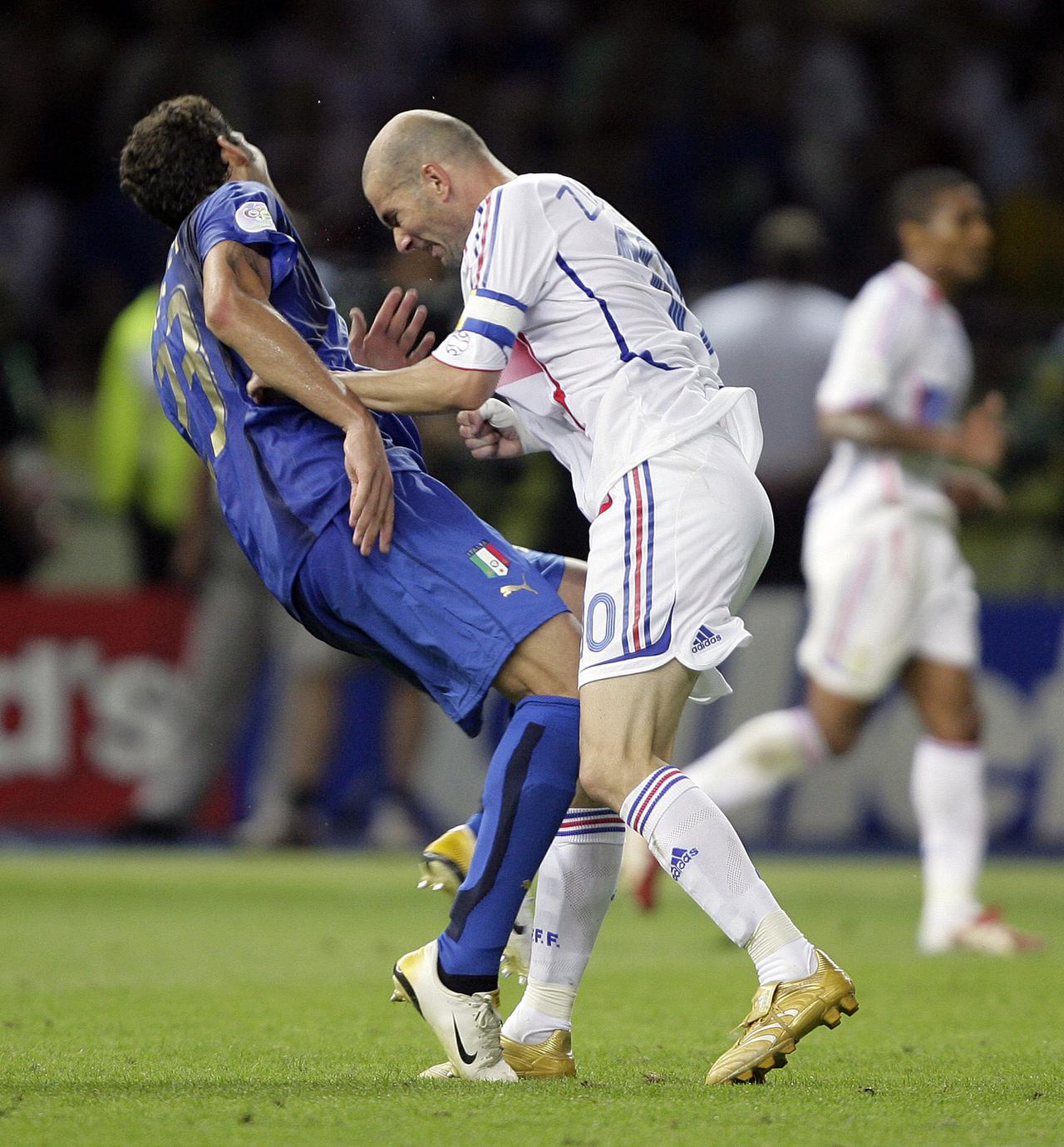 Italy's Marco Materazzi falls on the pitch after being head-butted by France's Zinedine Zidane (R) during their World Cup 2006 final soccer match in Berlin in this July 9, 2006 file photo. France captain Zinedine Zidane was sent off in extra time after headbutting Italy's Marco Materazzi in the Berlin World Cup soccer final with the score tied at 1-1. Materazzi had levelled the score after Zidane scored the opening goal from a penalty. Italy went on to win the penalty shootout 5-3. Picture taken July 9, 2006. To match feature -DECADE/TIMELINE HOLLAND OUT REUTERS/Peter Schols/GPD/Handout (SPORT SOCCER) [Peter Schols]