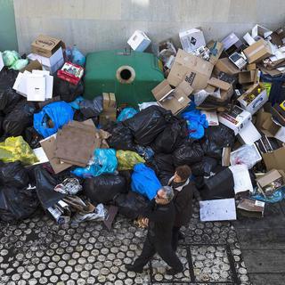 Dimanche 22 décembre: des piétons dans une rue ddu centre de Malaga jonchée de détritus en période de grève de trois jours de la voirie. [Jorge Zapata]