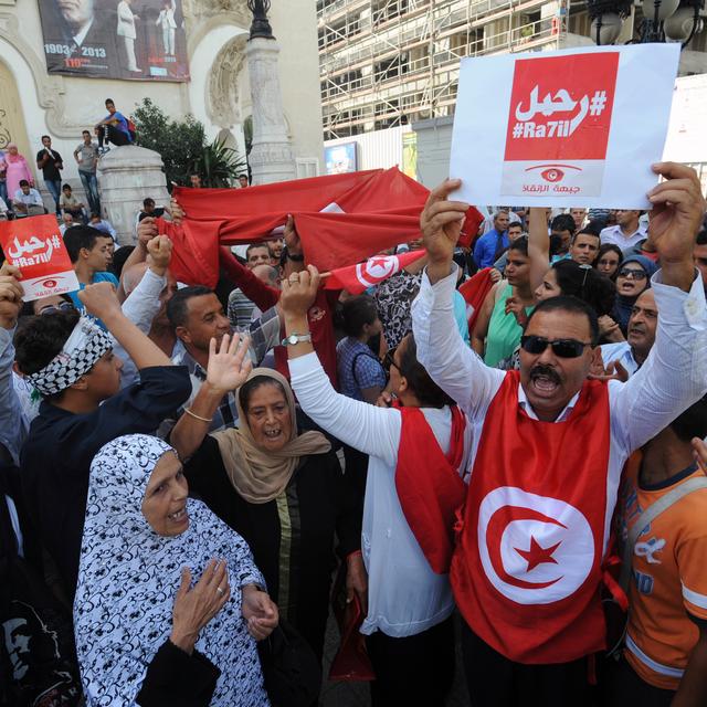 Un manifestant tunisien brandit une pancarte invitant le gouvernement à démissionner, le 23 octobre 2013. [Fethi Belaid]