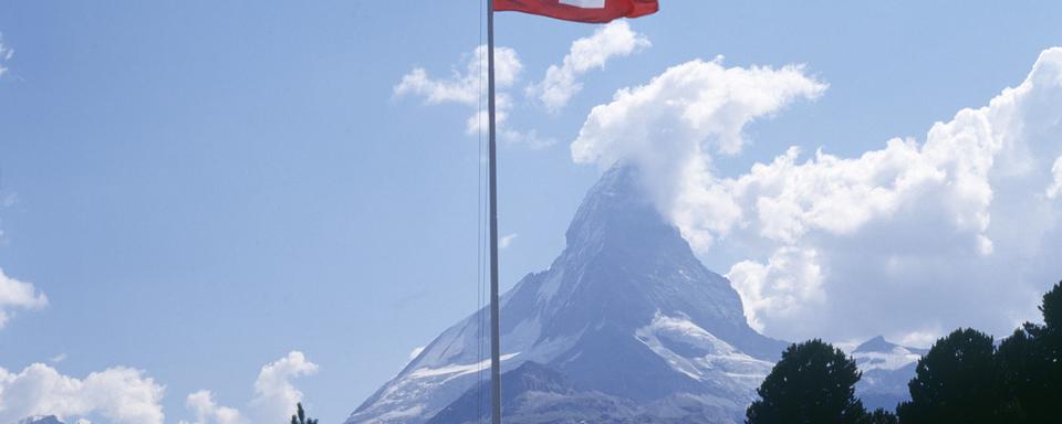 Un drapeau suisse devant le Cervin, tout un symbole helvétique... [Keystone - Str]