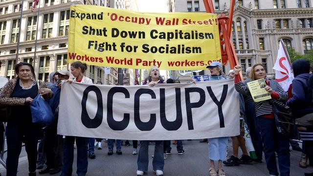 Le mouvement "Occupy Wall Street" révèlent les dessous des rachats de dettes aux USA. [EPA/Keystone - Justin Lane]