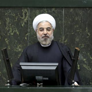 La réforme économique menée en Iran, ici le président Hassan Rohani, permet de renouer avec les relations commerciales internationales. [AP/Keystone - Ebrahim Noroozi]