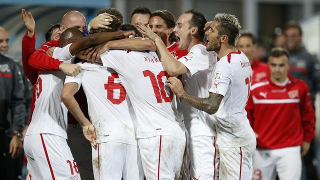 Switzerland's players celebrate after Switzerland's Michael Lang scored the 0-2 during the FIFA World Cup 2014 group E qualifying soccer match between Albania and Switzerland at the Qemal Stafa stadium in Tirana, Albania, Friday, October 11, 2013. (KEYSTONE/Peter Klaunzer) [Peter Klaunzer - PETER KLAUNZER]