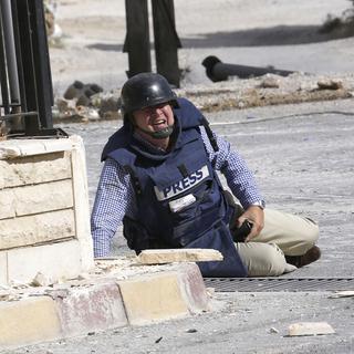 Un reporter durant un tir de sniper à Maalula en Syrie en septembre 2013. [Anwar Amro]