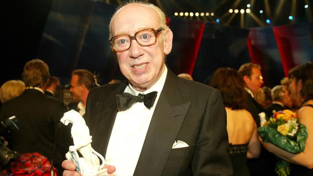 L'acteur Horst Tappert, qui incarnait l'inspecteur Derrick, tenant le prix du film bavarois, en 2003. [AFP - Johannes Simon.]