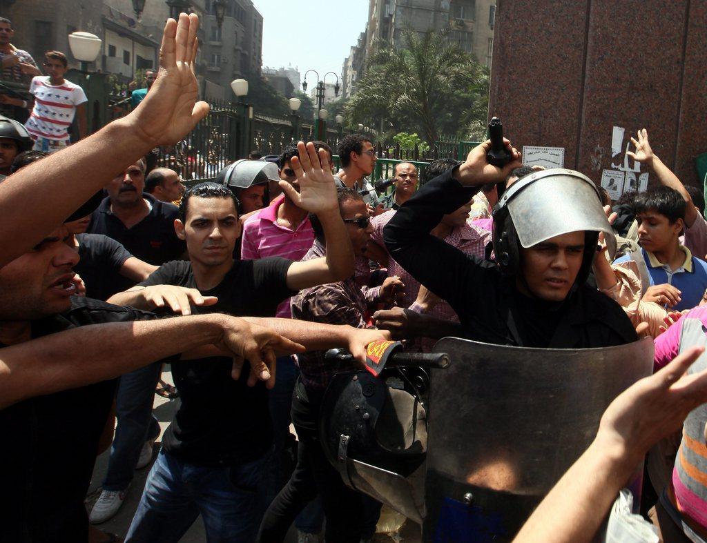 Des pro-Morsi se font attaquer par des opposants au président déchu lors de leur sortie de la mosquée al-Fatah samedi. [EPA/Khaled Elfiqi]