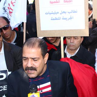 Chokri Belaïd, opposant laïque tunisien, lors d'une manifestation contre la violence faite aux femmes, en 2012. [Chedly Ben Ibrahim]