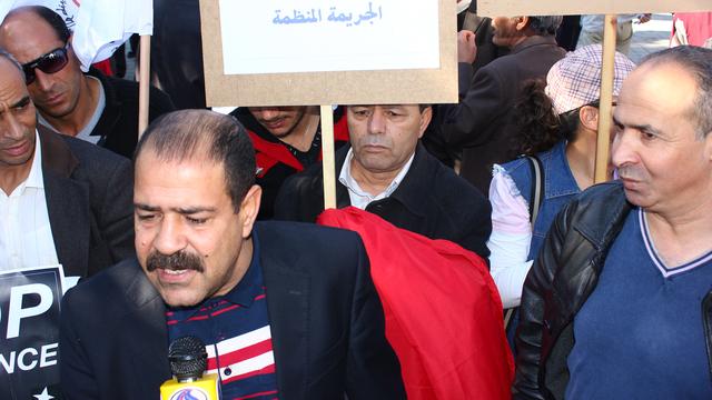 Chokri Belaïd, opposant laïque tunisien, lors d'une manifestation contre la violence faite aux femmes, en 2012. [Chedly Ben Ibrahim]