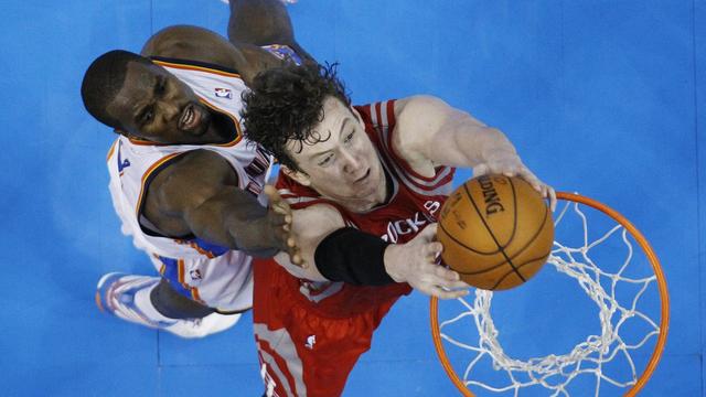 Houston Rockets center Omer Asik (3) dunks in front of Oklahoma City Thunder forward Serge Ibaka (9) in the third quarter of Game 1 of their first-round NBA basketball playoff series in Oklahoma City, Sunday, April 21, 2013. Oklahoma City won 120-91. (AP Photo/Sue Ogrocki) [Sue Ogrocki]