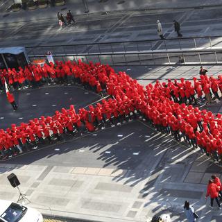 A Séoul, des étudiants forment un ruban rouge - symbole de la lutte contre le sida - pour marquer "sa" journée mondiale. [AP/Ahn Young-joon]