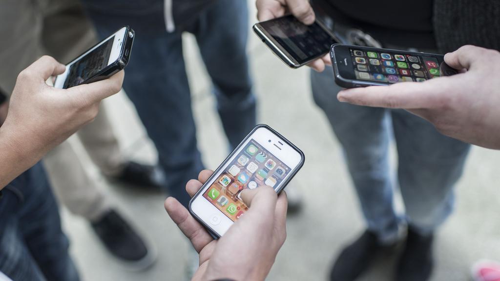 Le smartphone est devenu l'outil privilégié des adolescents. [Christian Beutler]