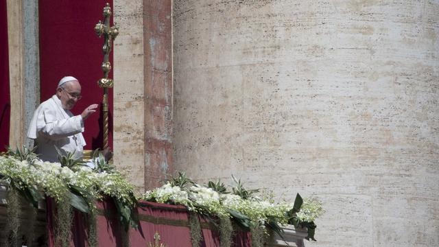 Pope Francis delivers the Urbi and Orbi (Latin for to the city and to the world) blessing from the balcony of St. Peter's Basilica at the end of the Easter Mass in St. Peter's Square at the the Vatican Sunday, April 20, 2014. Pope Francis celebrated the Easter Sunday Mass in St. Peter's Square, packed by joyous pilgrims, tourists and Romans and bedecked by spring flowers. (AP Photo/Alessandra Tarantino) [Alessandra Tarantino]