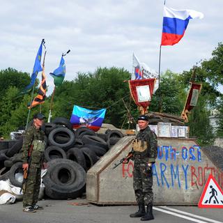Des pro-Russes gardent un checkpoint sur la route entre Lougansk et Donetsk. Les enlèvements sont légion dans la région, selon Amnesty International. [AFP - Dominque Faget]