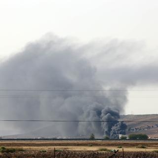 Une épaisse fumée noire flottait vendredi au-dessus de la ville d'Aïn al-Arab, à la frontière turco-syrienne. [Ibrahim Erikan / Anadolu Agency]