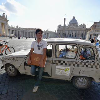 ITALY, Rome : French Vincent Gelot, 26, poses next to his 4L car on St. Peter's square, on August 26, 2014 at the Vatican. Vincent Gelot spent the past two years traveling around the world, visiting Christian communities in 23 countries and saving their testimonies in a large leather book which ends with a dedication by the Pope who wrote "Thank you so much for this testimony of the Eastern Church, a church that has given so many saints and now suffer. I pray for you all, I am close to you." AFP PHOTO / ANDREAS SOLARO [Andreas Solaro]